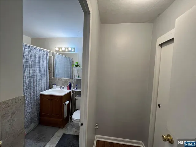 a bathroom with a sink a toilet and mirror