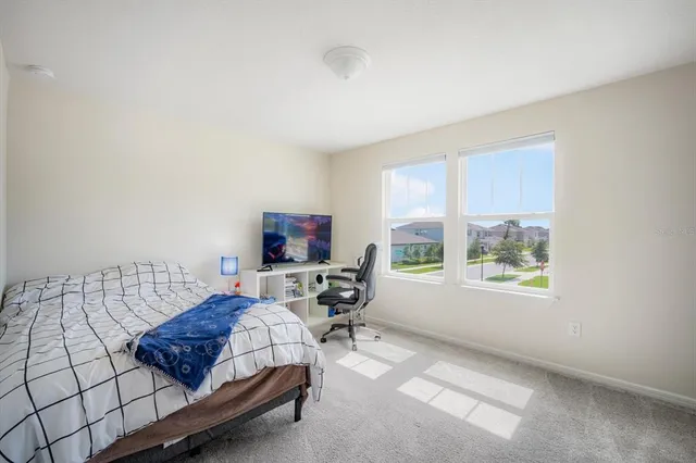 a bedroom with furniture and a window