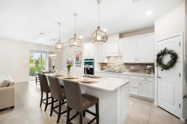 a kitchen with kitchen island granite countertop a sink a center island and cabinets