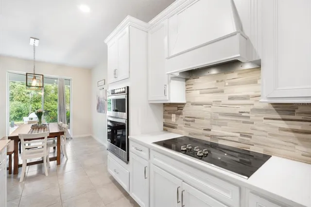 a kitchen with stainless steel appliances granite countertop a stove and a refrigerator