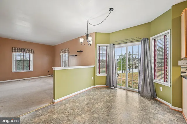 a kitchen with stainless steel appliances granite countertop a sink a stove and a wooden cabinets