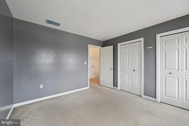 a view of an empty room and a window