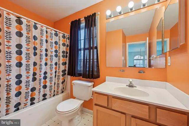 a room with pool table and windows