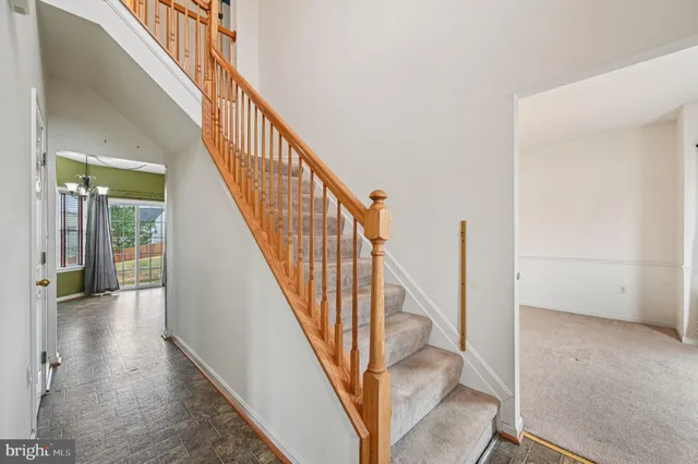 a view of an empty room with a kitchen