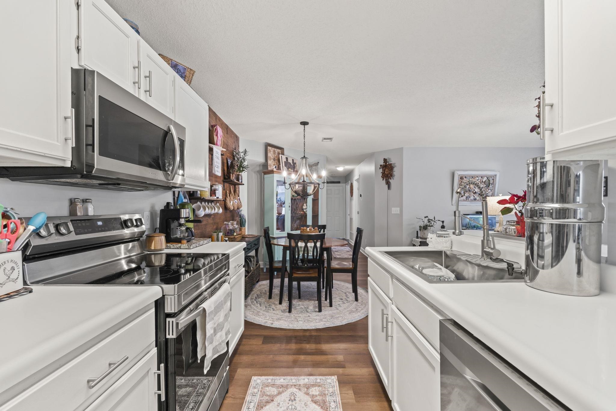 4383 Daphne Lane, Unit F Murrells Inlet, SC 29576 - Photo 10 of 35 Kitchen with appliances with stainless steel finishes, white cabinetry, and light countertops