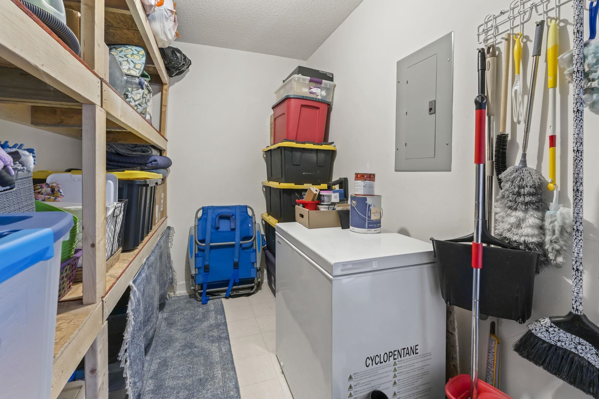 4383 Daphne Lane, Unit F Murrells Inlet, SC 29576 - Photo 12 of 35 Laundry area featuring electric panel, light tile patterned floors, and a textured ceiling