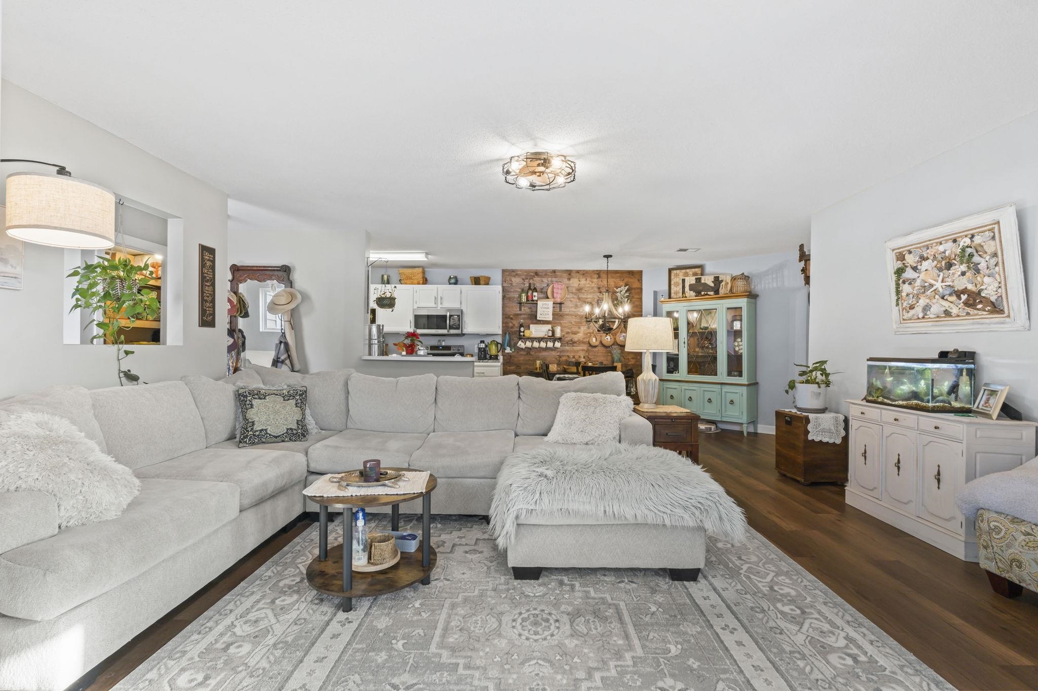 4383 Daphne Lane, Unit F Murrells Inlet, SC 29576 - Photo 13 of 35 Living area featuring a chandelier and dark wood-style flooring