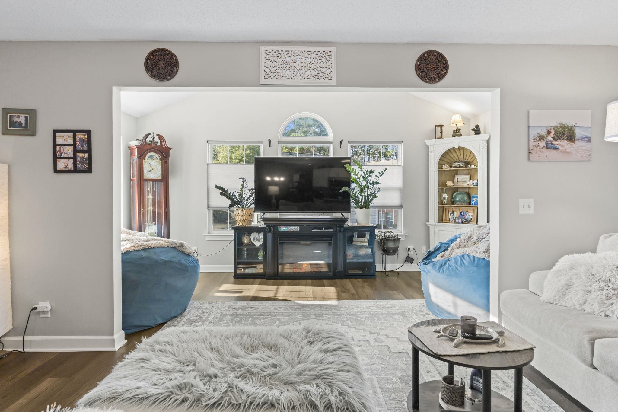 4383 Daphne Lane, Unit F Murrells Inlet, SC 29576 - Photo 15 of 35 Living room with wood finished floors, vaulted ceiling, and a glass covered fireplace
