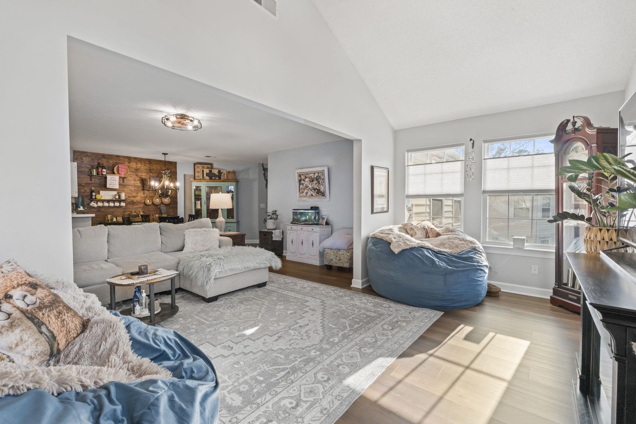 4383 Daphne Lane, Unit F Murrells Inlet, SC 29576 - Photo 17 of 35 Living room featuring vaulted ceiling, wood finished floors, and a chandelier