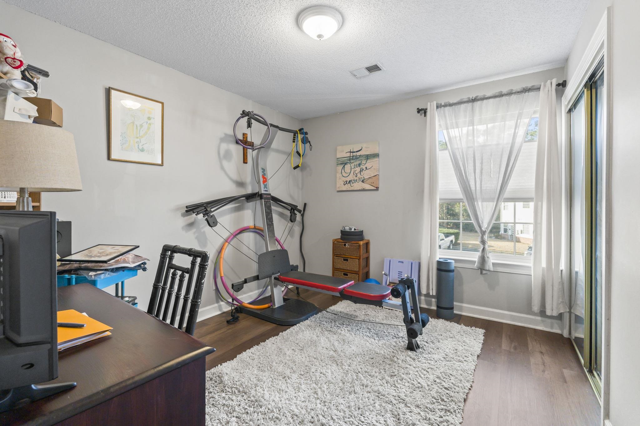 4383 Daphne Lane, Unit F Murrells Inlet, SC 29576 - Photo 28 of 35 Exercise area featuring a textured ceiling and dark wood-type flooring