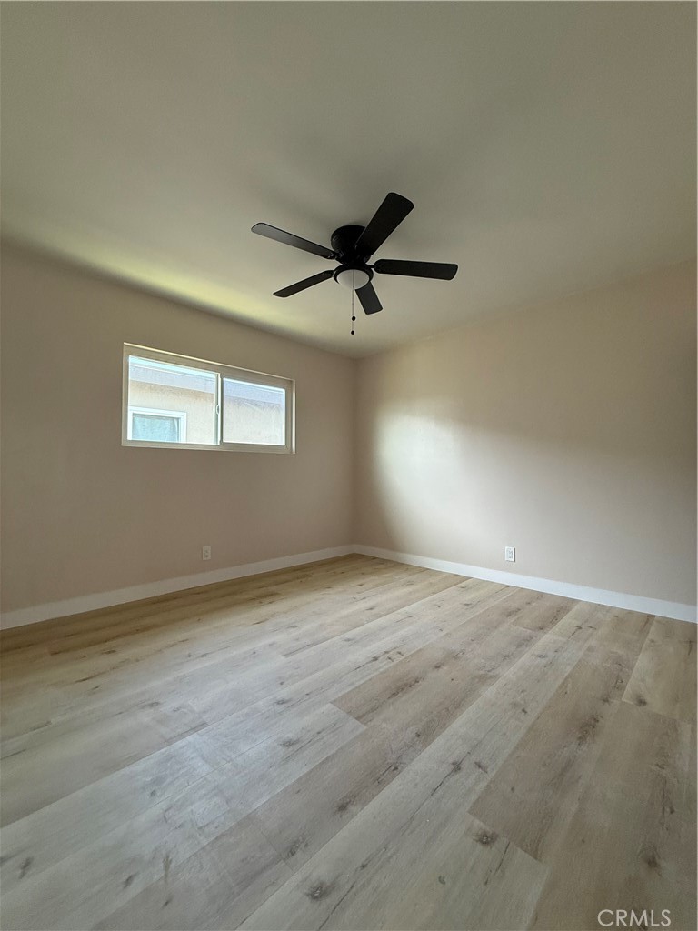 10018 Foster Road, Unit 10020 (1/2) Bellflower, CA 90706 - Photo 4 of 8 an empty room with a ceiling fan and window