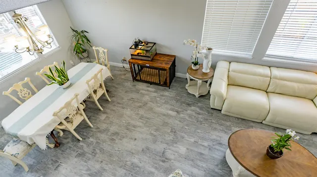 a kitchen with stainless steel appliances granite countertop a stove a sink dishwasher and white cabinets with wooden floor