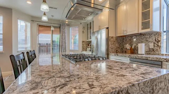 a living room with large window and furniture