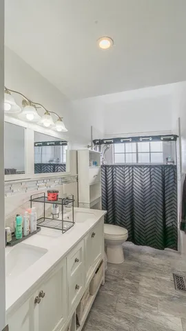 a bathroom with a sink toilet and shower