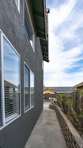a view of backyard with outdoor seating and green space