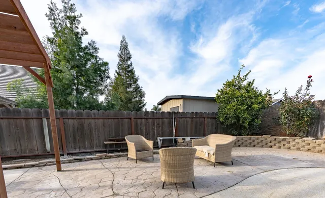 a view of a house with backyard and sitting area