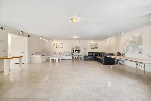 a living room with furniture and kitchen view