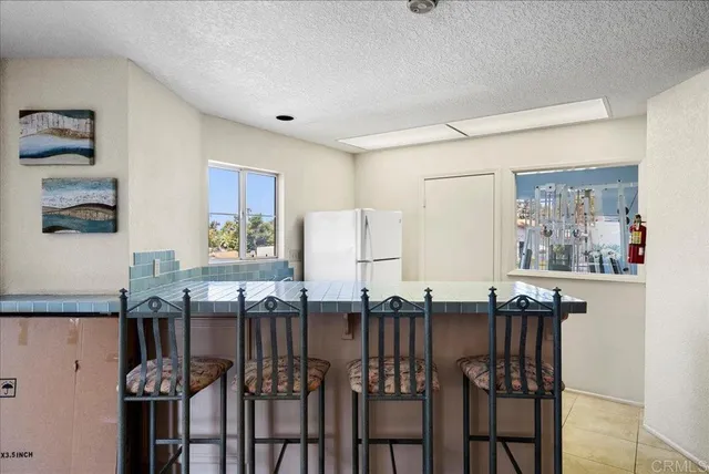 a kitchen with granite countertop a table and chairs