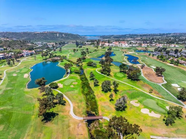 an aerial view of residential houses with outdoor space and swimming pool