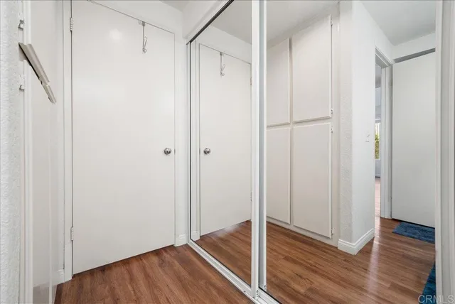a view of hallway with wooden floor