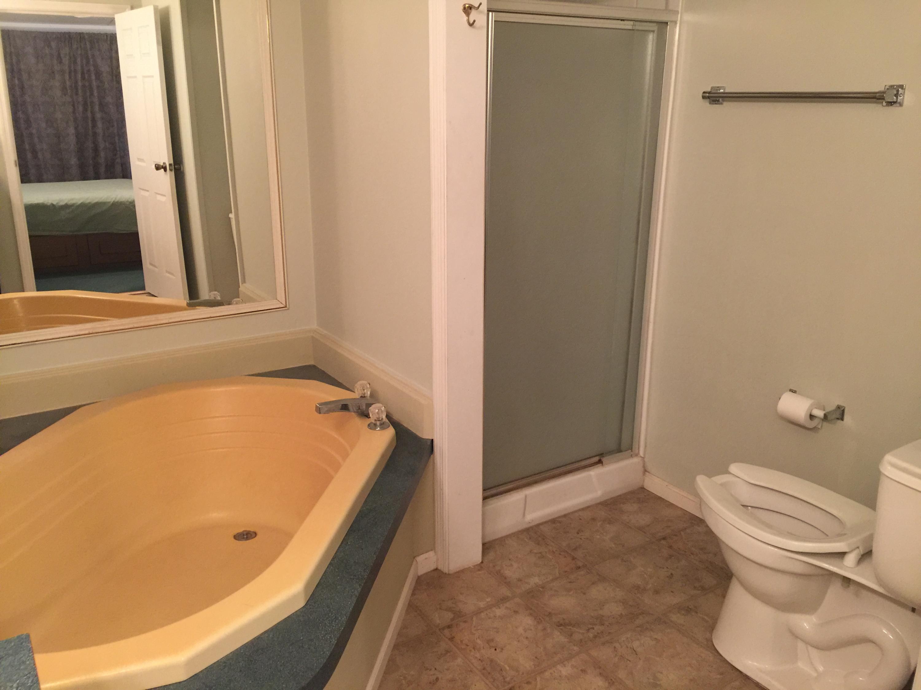 10441 Marina Way Boca Raton, FL 33428 - Photo 9 of 10 a bathroom with a tub and toilet