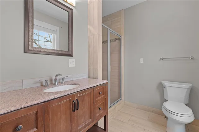 a bathroom with a toilet a sink and mirror
