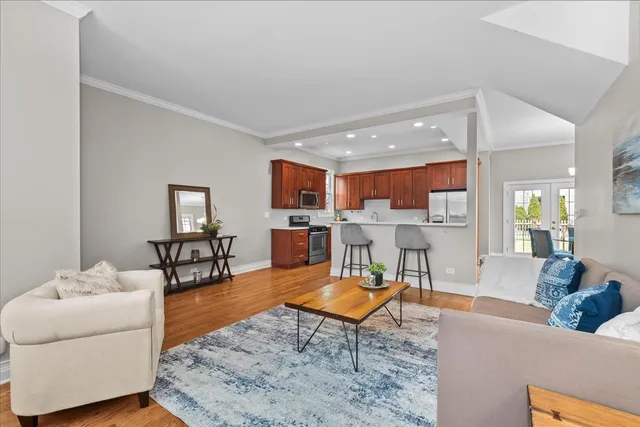 a living room with furniture and a view of kitchen