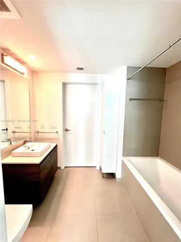 a bathroom with a bathtub and a sink