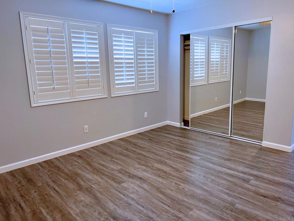 1379 Peach Avenue El Cajon, CA 92021 - Photo 13 of 22 a view of an empty room with wooden floor and a window