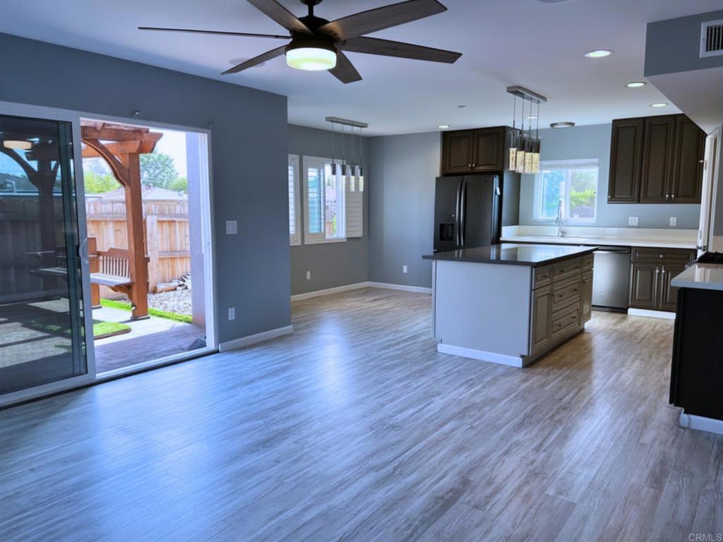 1379 Peach Avenue El Cajon, CA 92021 - Photo 7 of 22 an open kitchen with wooden floor and outdoor space