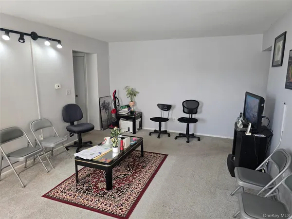 a living room with furniture and air hockey table