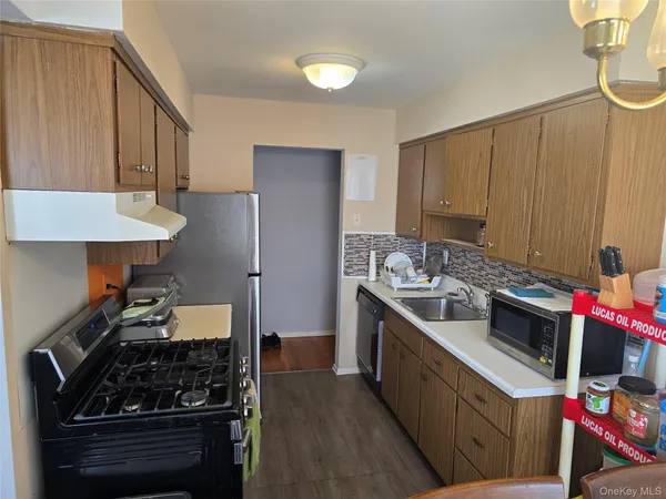 a kitchen with stainless steel appliances a stove a sink and a refrigerator