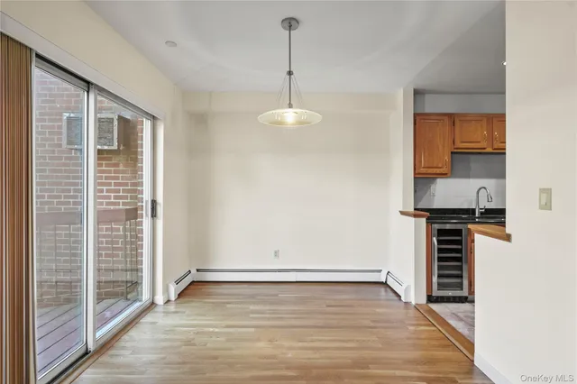 a view of a kitchen with a sink a refrigerator and window