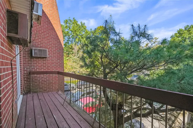 a view of a balcony with wooden floor