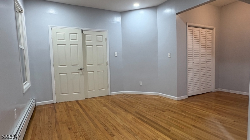 82 Scheerer Avenue, Unit 2 Newark, NJ 07112 - Photo 3 of 7 wooden floor and closet in a room
