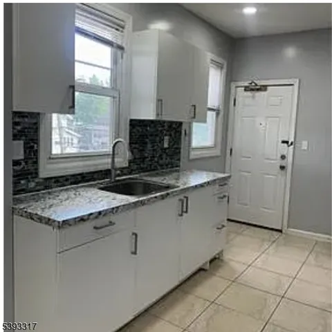 a kitchen with stainless steel appliances granite countertop a sink and a stove