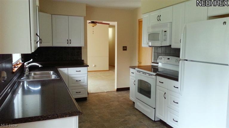 1998 Wyndham Road Akron, OH 44313 - Photo 7 of 25 Beautiful laminate flooring and countertops, white appliances and cabinetry w/pulls. New paint and plumbing.