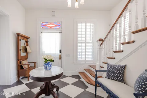 a kitchen with white cabinets a sink a stove a refrigerator and a stove