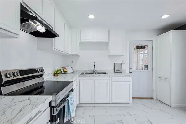 a kitchen with stainless steel appliances granite countertop a sink and cabinets