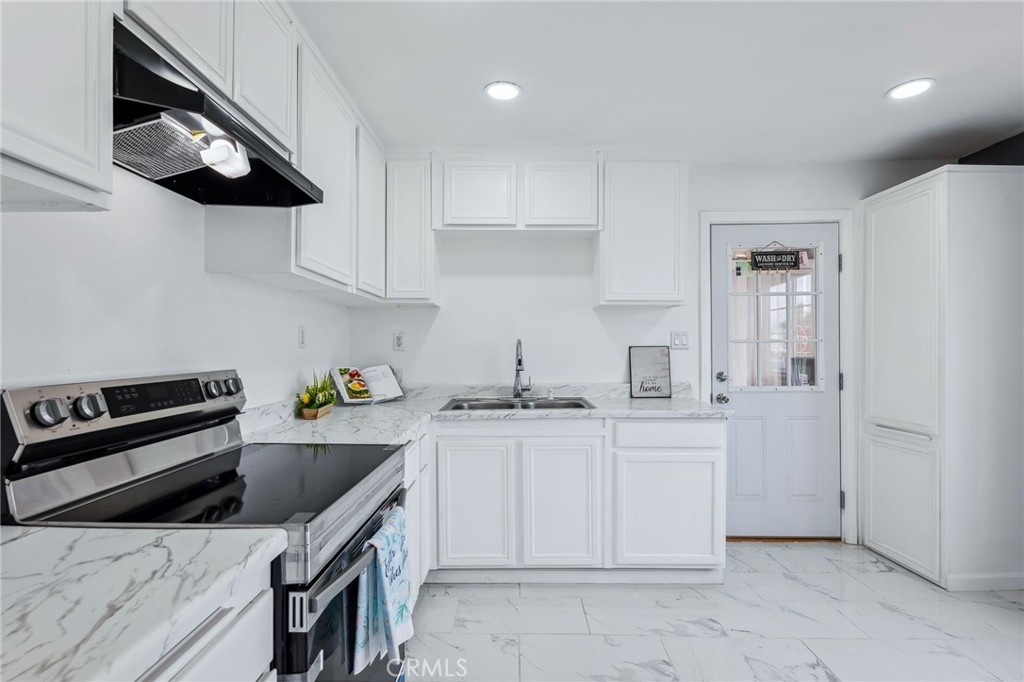 501 B Street Needles, CA 92363 - Photo 13 of 32 a kitchen with stainless steel appliances granite countertop a sink and cabinets