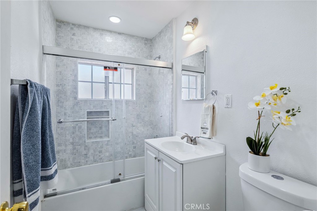 501 B Street Needles, CA 92363 - Photo 16 of 32 a bathroom with a sink a toilet and shower