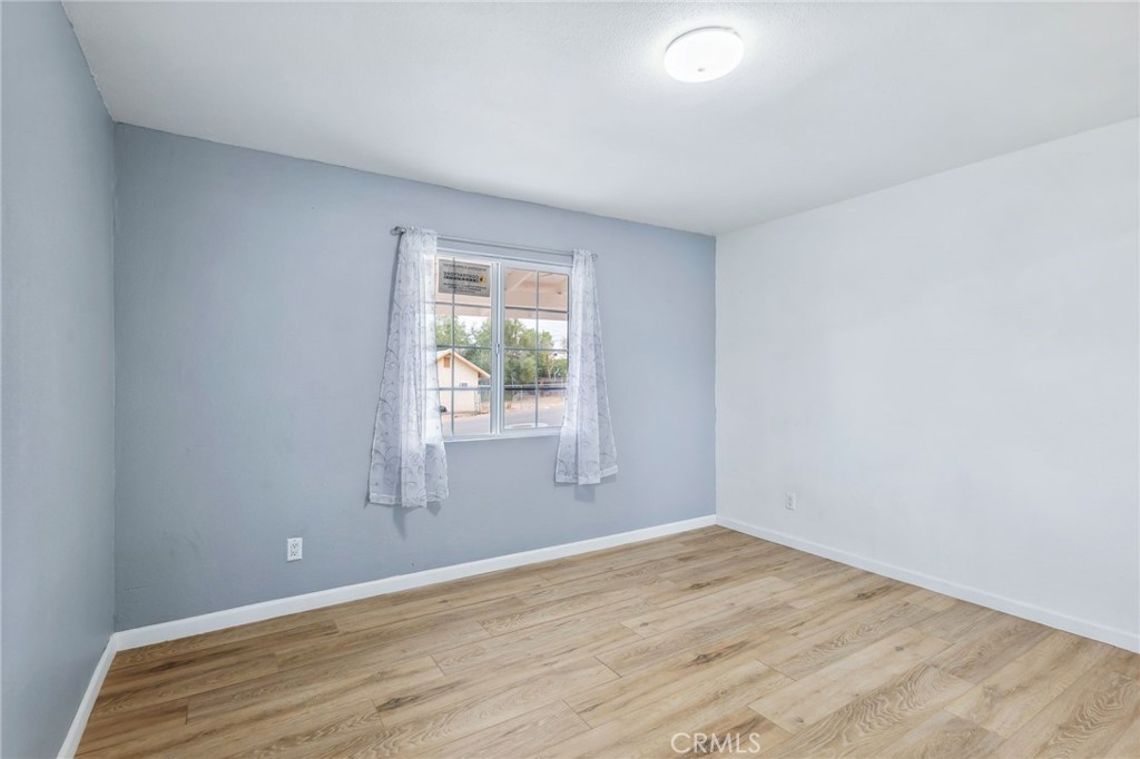 501 B Street Needles, CA 92363 - Photo 18 of 32 an empty room with wooden floor and windows