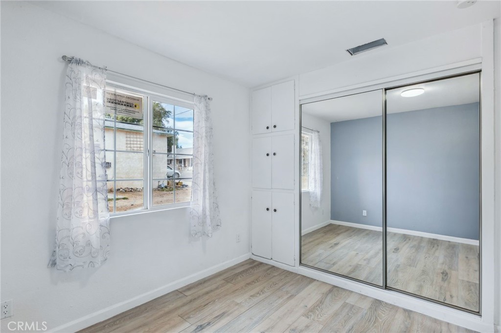 501 B Street Needles, CA 92363 - Photo 24 of 32 an empty room with wooden floor and door