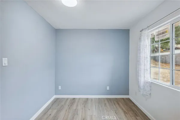 a view of a room with wooden floor and windows