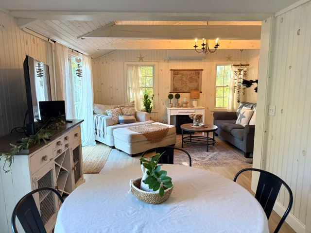 a living room with furniture a large window and a flat screen tv