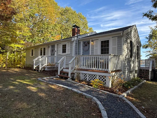 a view of a house with backyard and sitting area