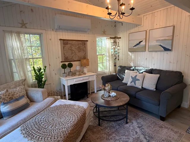 a living room with furniture fireplace and a table