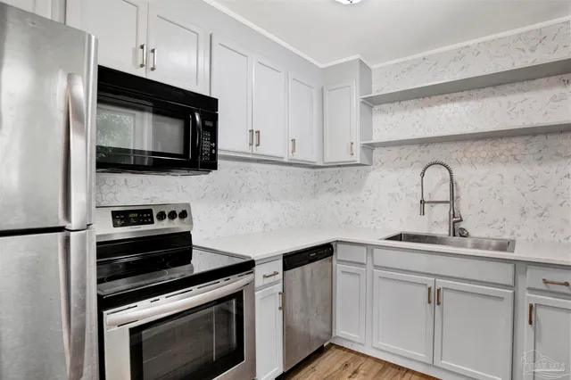 a kitchen with a sink stove and microwave