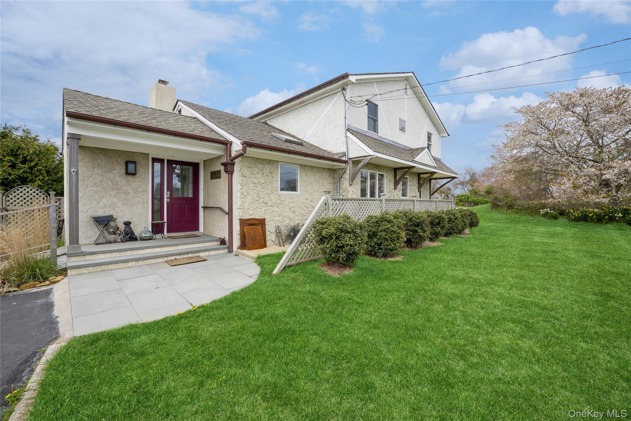 155 Essex Street Montauk, NY 11954 - Photo 1 of 11 a view of a white house with a big yard and potted plants