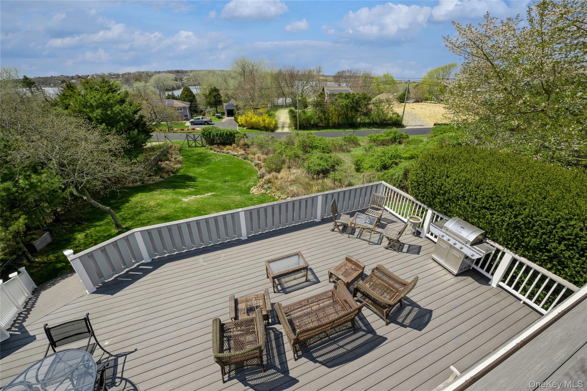 155 Essex Street Montauk, NY 11954 - Photo 2 of 11 a view of a balcony with wooden floor and outdoor seating
